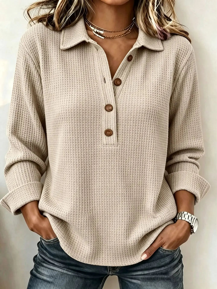 Woman wearing khaki waffle knit top with folded cuffs
