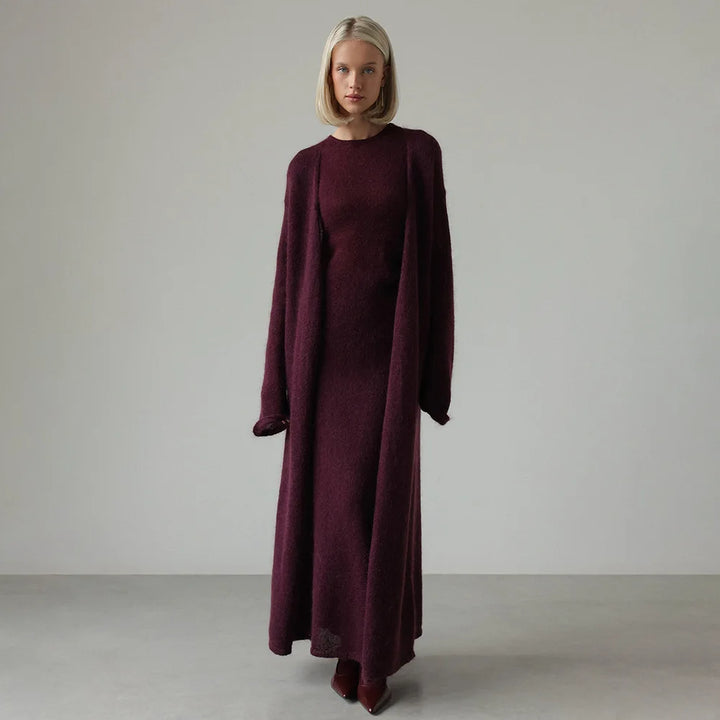 Woman standing in purple sweater dress and matching duster set