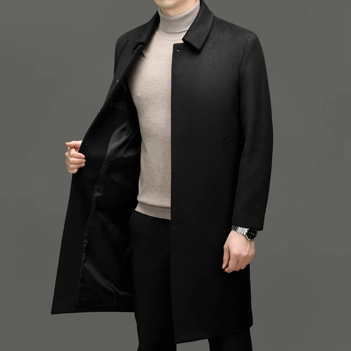 Man wearing black wool coat, open front showing lining