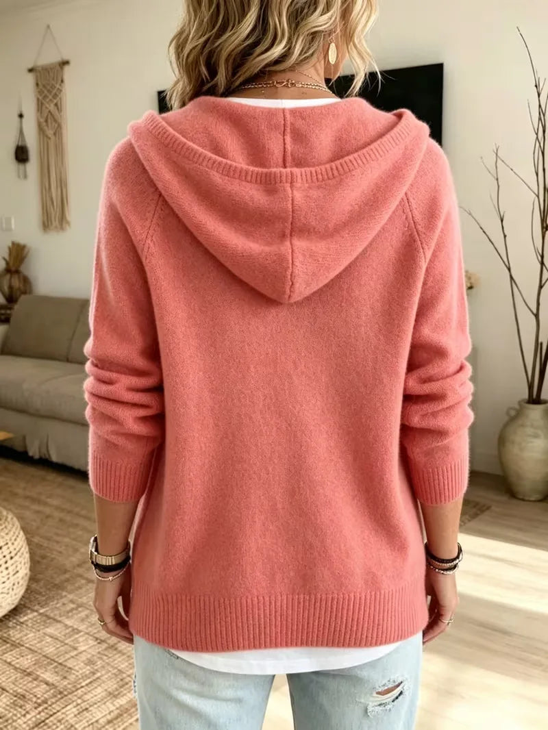 Back view of pink knit drawstring hoodie showing hood and ribbed hem