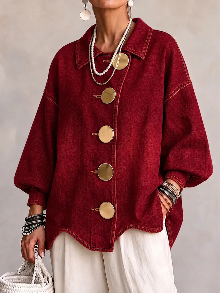 Woman wearing burgundy denim jacket with large gold buttons, front view