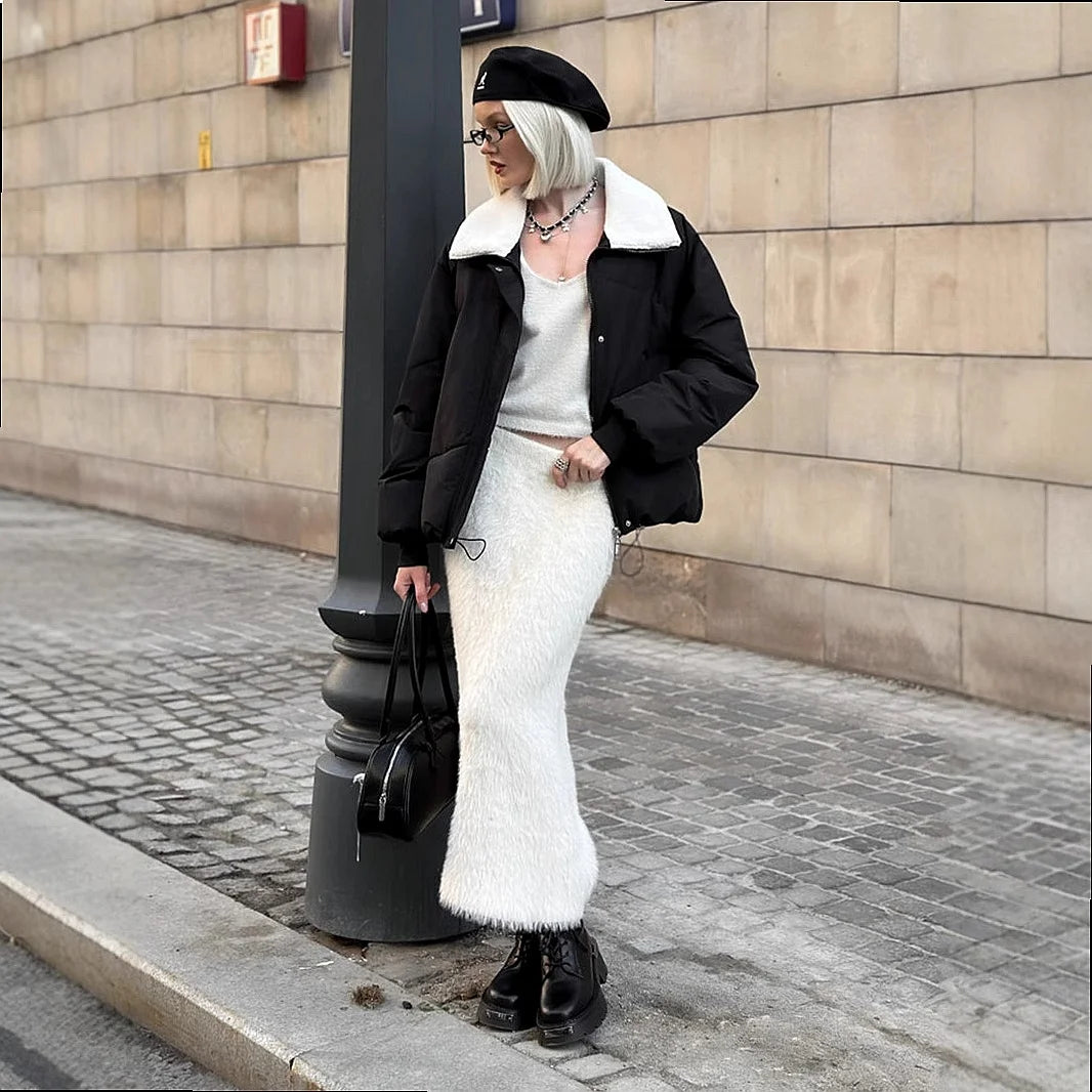 Side view of white fuzzy knit maxi skirt styled with beret and boots