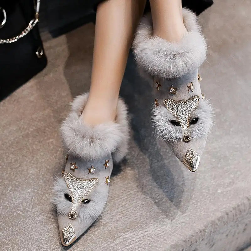 Gray faux fur ankle boots with crystal fox face detail, top view on model