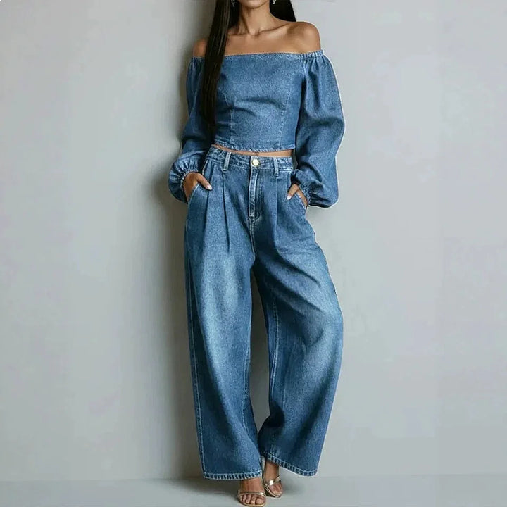 Woman wearing light blue denim off-shoulder crop top and wide leg pants set, front view