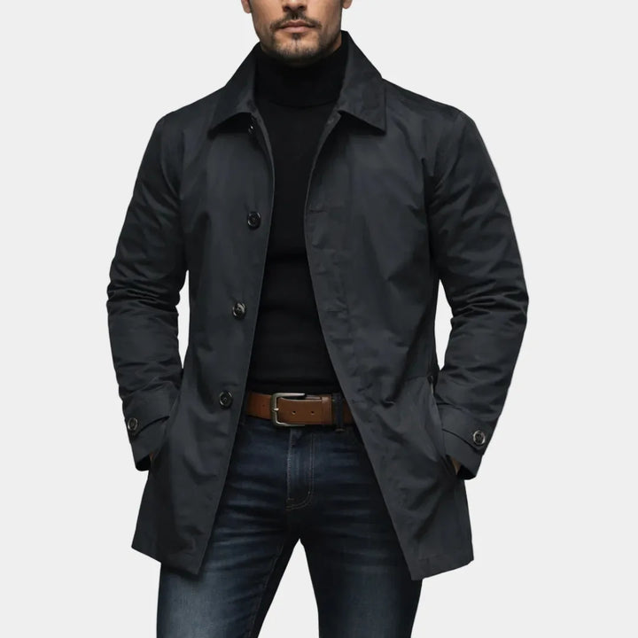 Black trench coat front view with side welt pockets