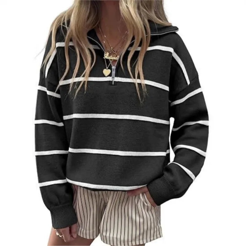 Woman wearing black and white striped quarter-zip sweater