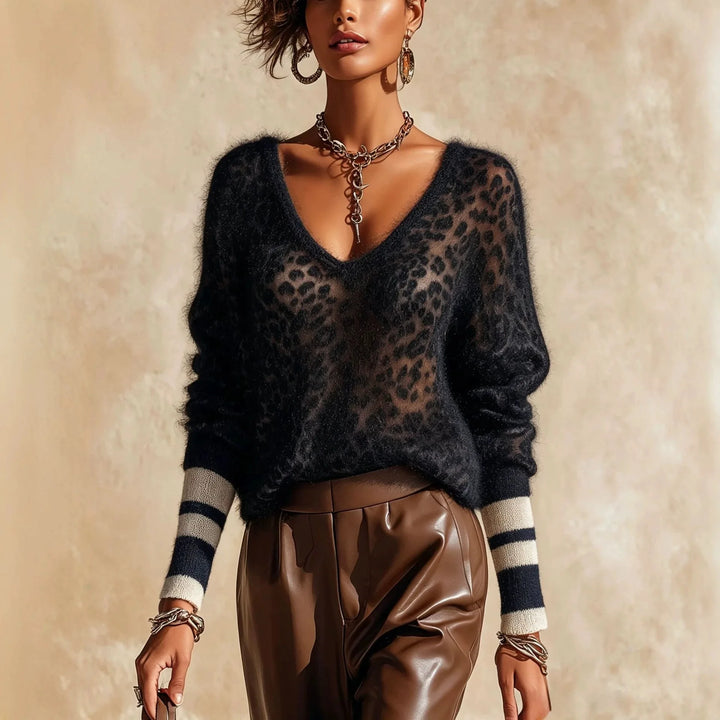Woman wearing black leopard print sheer V-neck sweater with striped cuffs