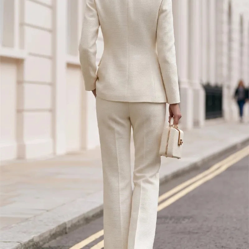 Back view of beige tweed blazer and flared trousers set