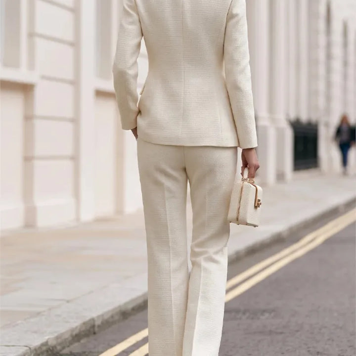 Back view of beige tweed blazer and flared trousers set