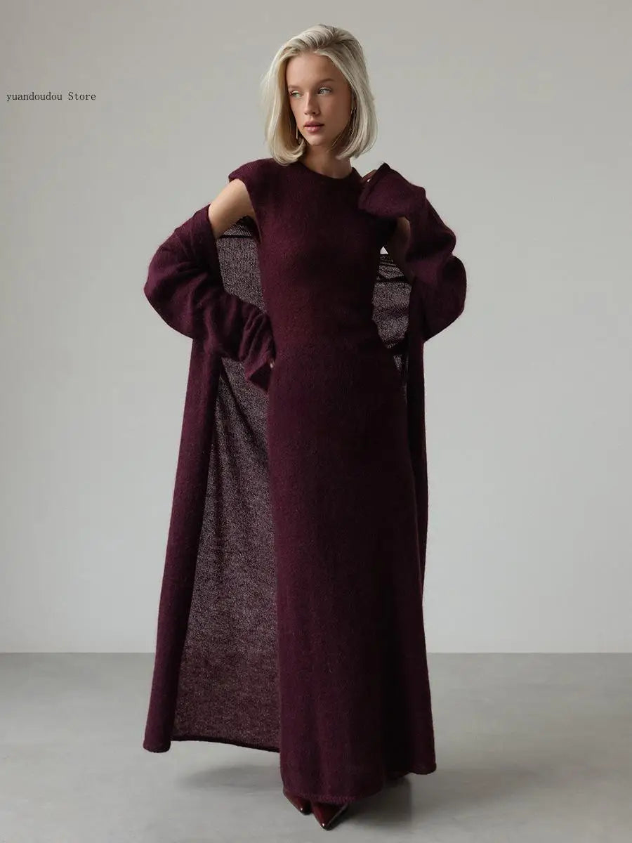 Woman wearing purple knit sweater dress with cutout shoulder duster