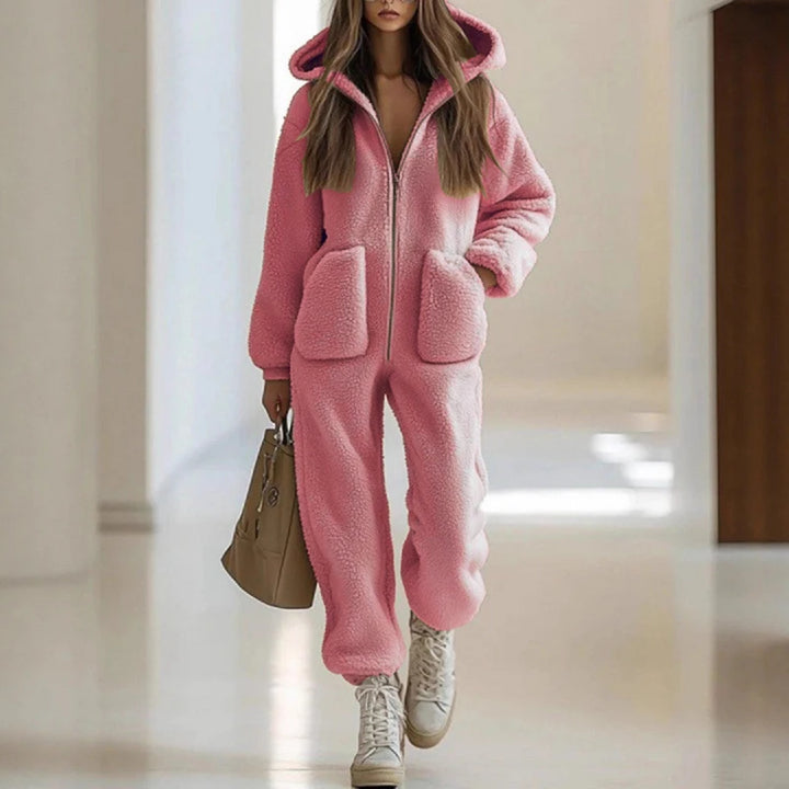 Woman wearing pink sherpa hooded jumpsuit with patch pockets