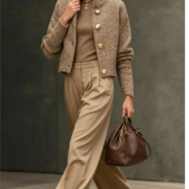 Woman walking in camel bouclé cardigan jacket with wide leg trousers