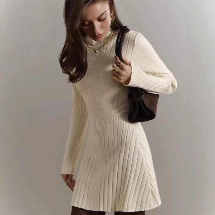 Woman in apricot ribbed knit A-line sweater dress with mock neck
