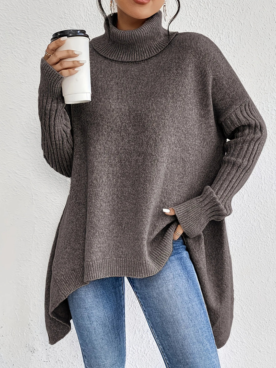 Woman wearing dark brown turtleneck sweater with asymmetric hem