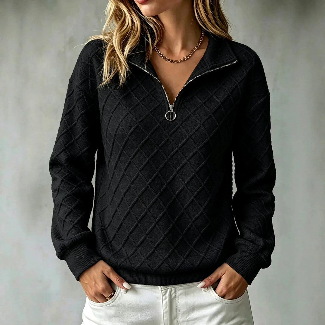 Woman wearing black diamond textured quarter zip pullover