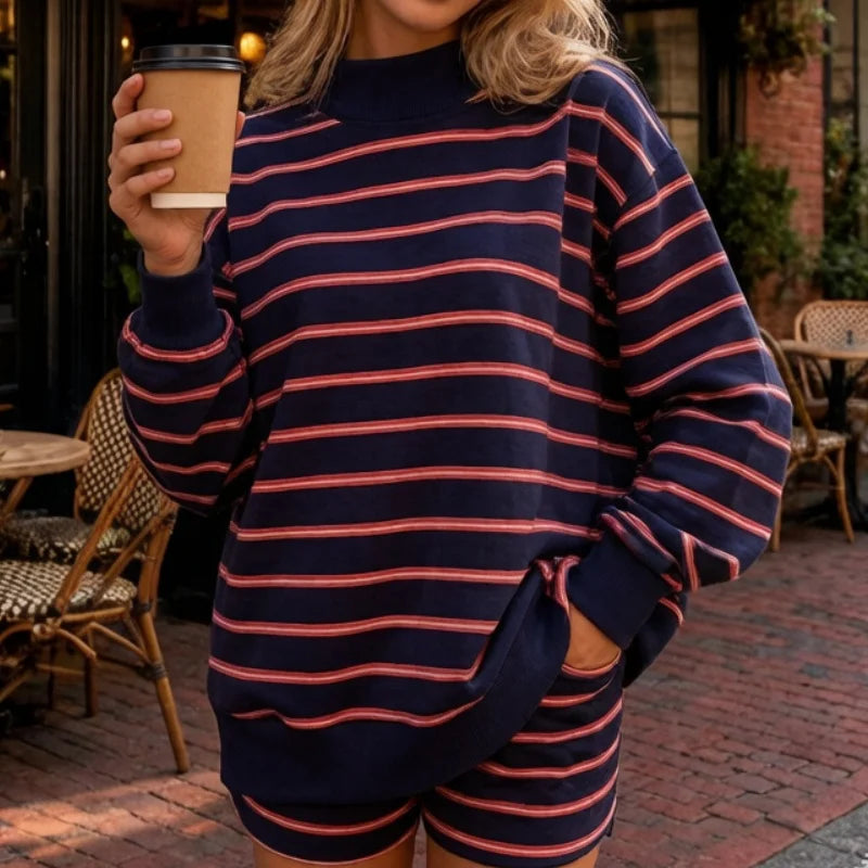 Woman wearing navy and red striped sweatshirt and shorts set