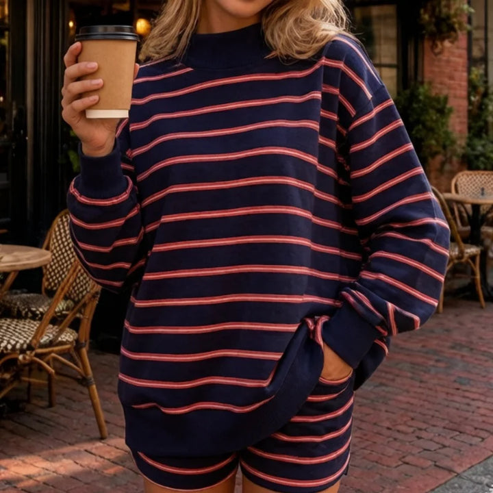 Woman wearing navy and red striped sweatshirt and shorts set