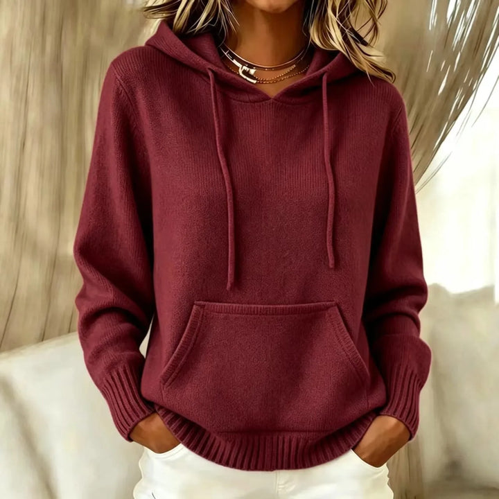 Woman wearing burgundy hooded knit sweater with kangaroo pocket