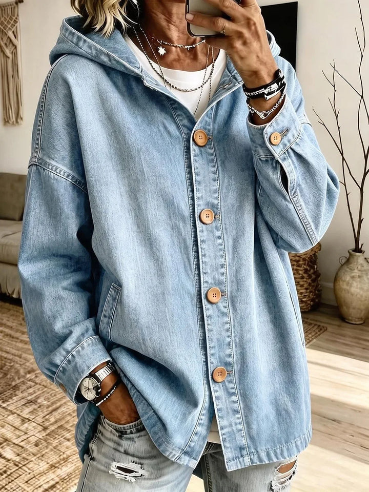 Close-up of light wash denim hooded jacket showing button detail