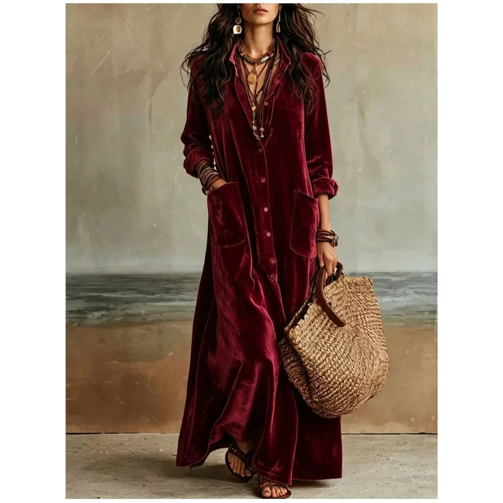 Woman wearing burgundy velvet button front maxi dress with patch pockets