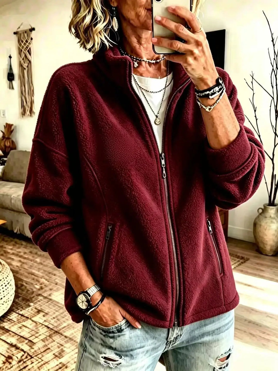 Woman wearing burgundy fleece full zip jacket with stand collar