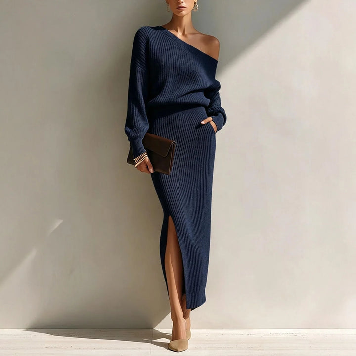 Woman wearing navy blue off shoulder ribbed knit sweater and skirt set