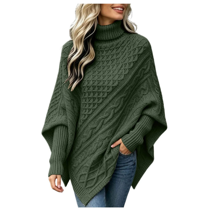 Woman wearing dark green cable knit asymmetric poncho sweater with turtleneck