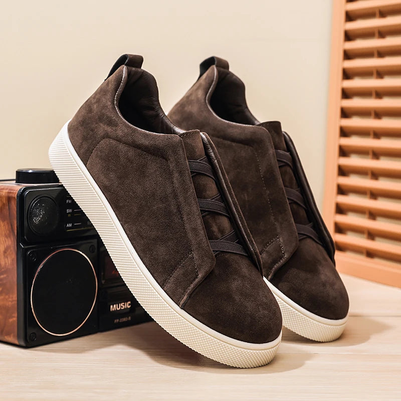 Pair of brown suede-look low-top sneakers with elastic crisscross band