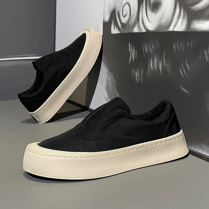 Black canvas slip-on sneaker angled view with platform sole