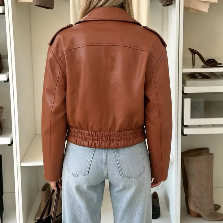 Back view of brown faux leather biker jacket with cinched hem
