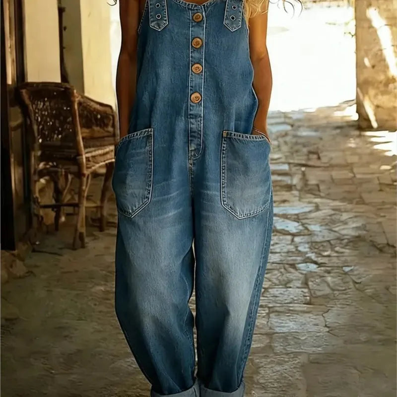 Woman wearing medium wash denim button front overalls with patch pockets