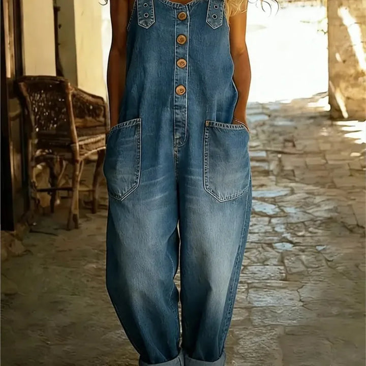 Woman wearing medium wash denim button front overalls with patch pockets