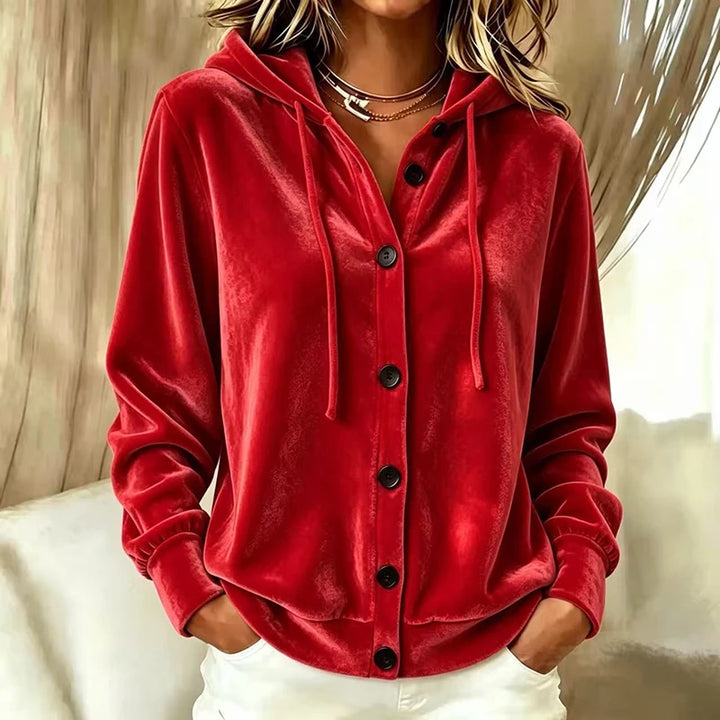 Woman wearing red velvet hooded button front jacket, front view