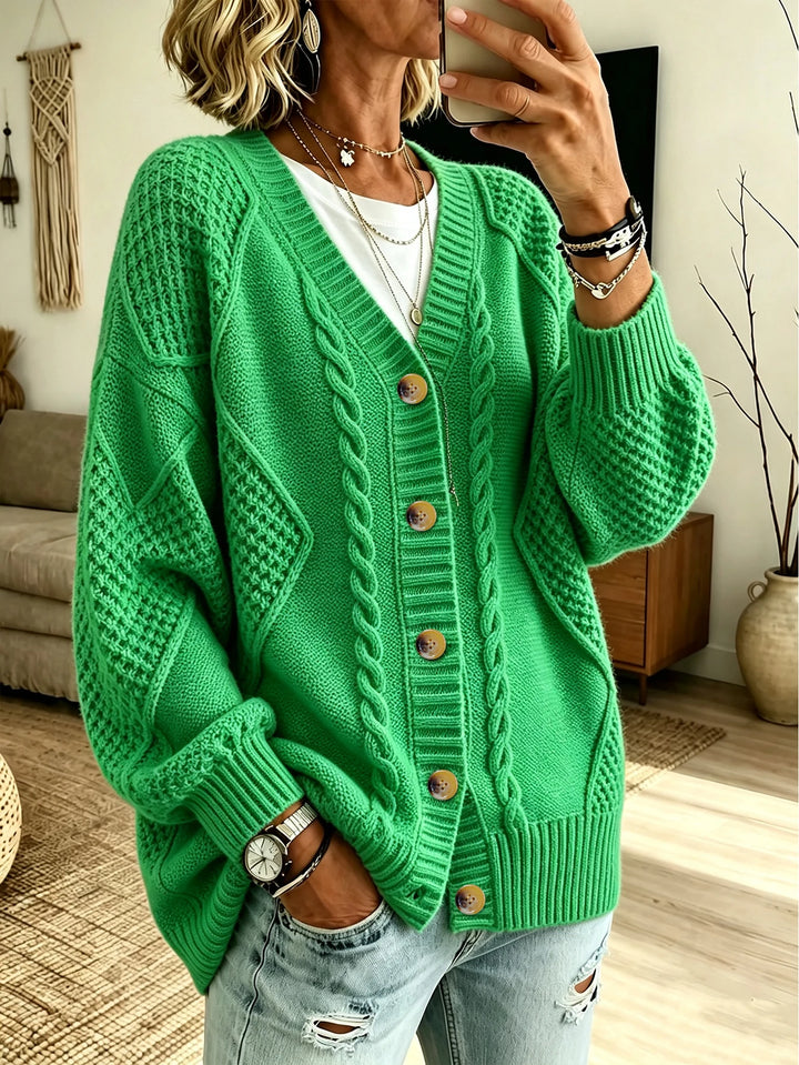 Woman wearing green cable knit button front cardigan