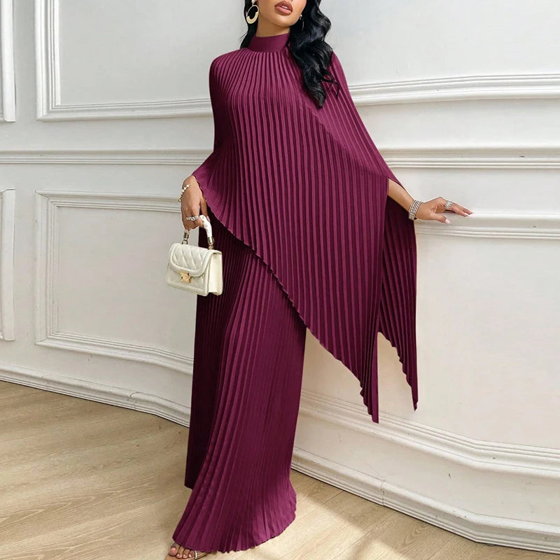 Woman wearing purple pleated cape top and wide leg pants two piece set