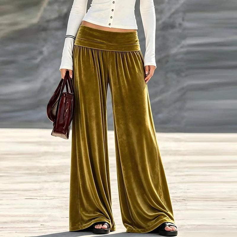 Woman wearing olive green velvet wide leg high waist pants, front view
