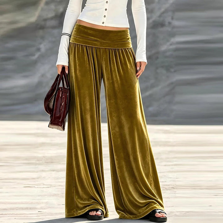 Woman wearing olive green velvet wide leg high waist pants, front view
