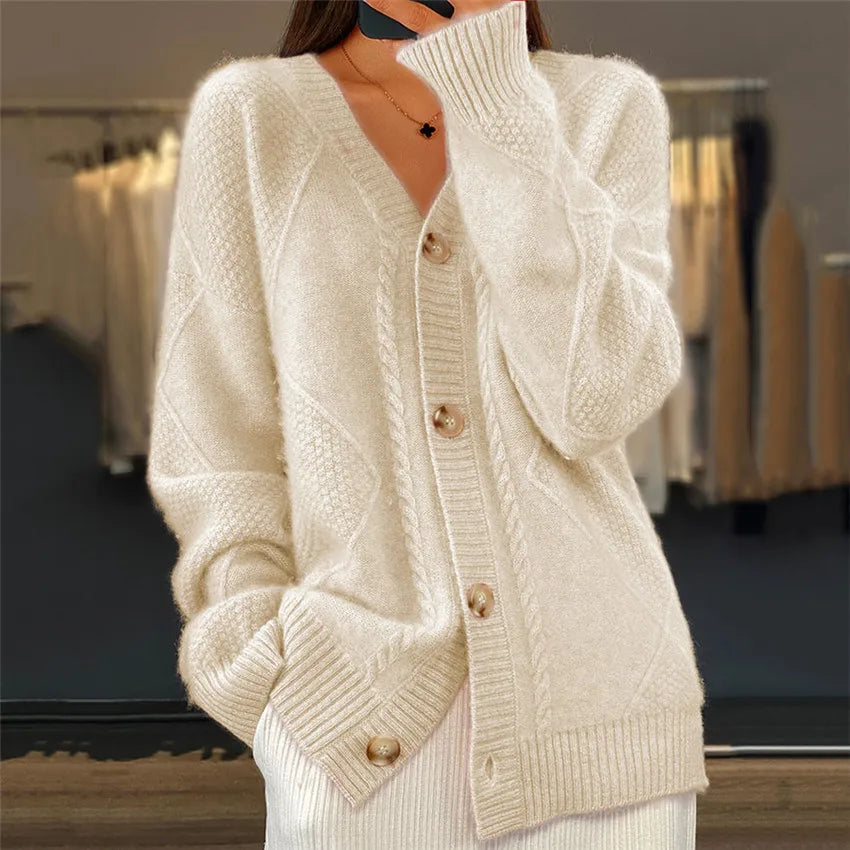 Woman wearing apricot cable knit button front cardigan