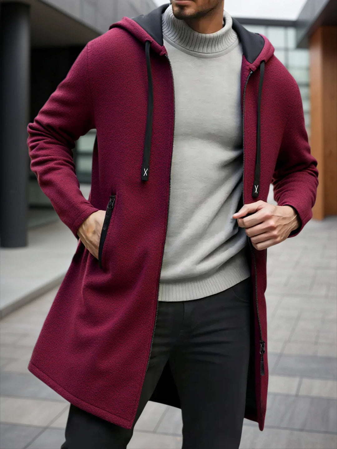 Man wearing burgundy hooded mid-length fleece jacket with drawstring hood