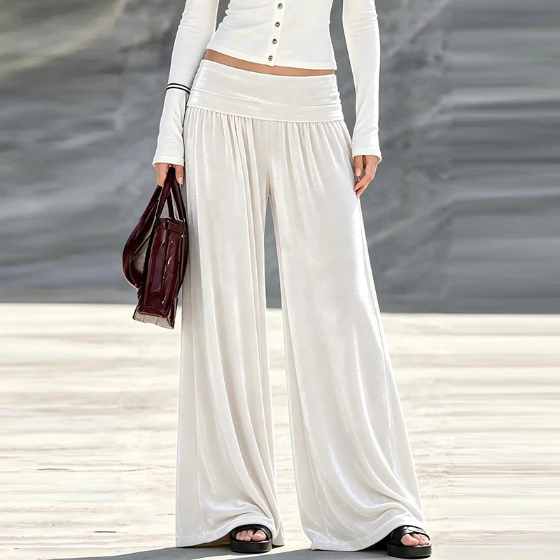 Woman wearing cream velvet wide leg high waist pants, front view