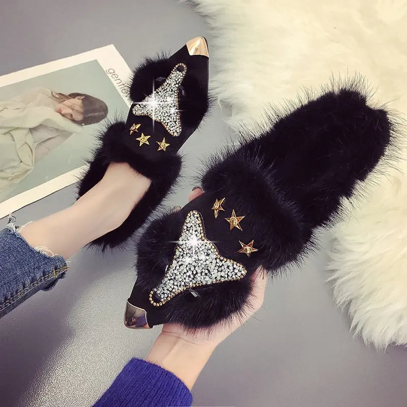 Black fur trim ankle boots held in hand showing fox applique detail
