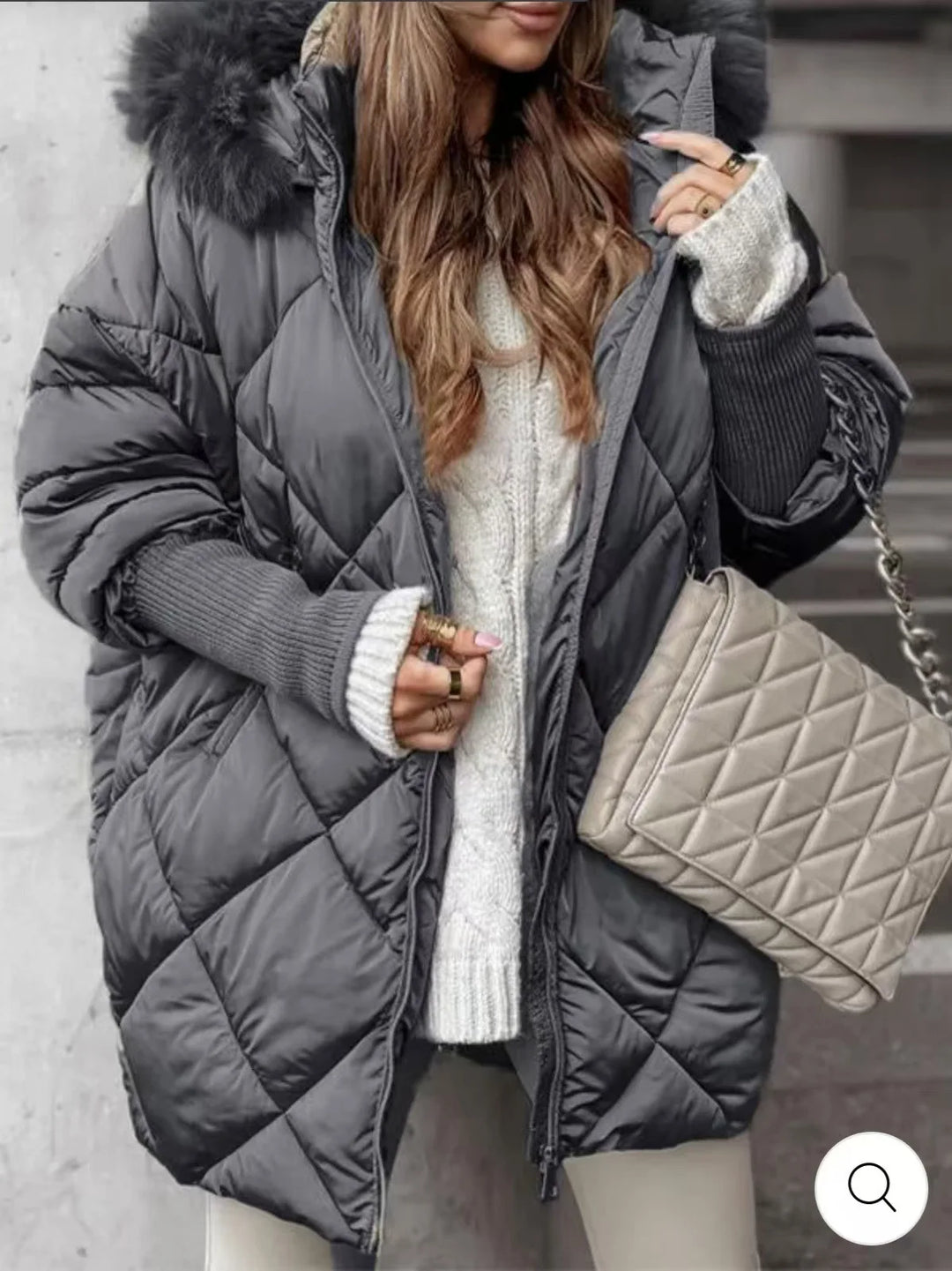 Woman wearing charcoal grey diamond quilted puffer coat with faux fur hood