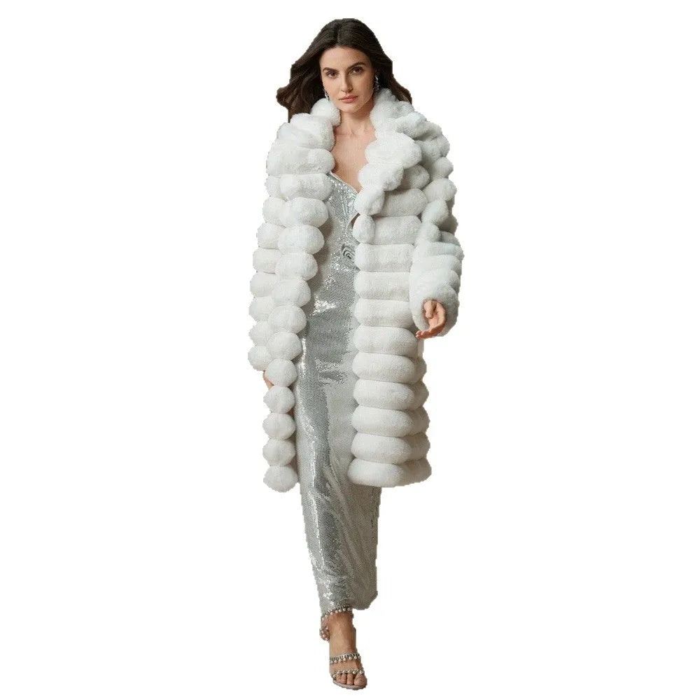 Model walking in white faux fur coat over sequin jumpsuit