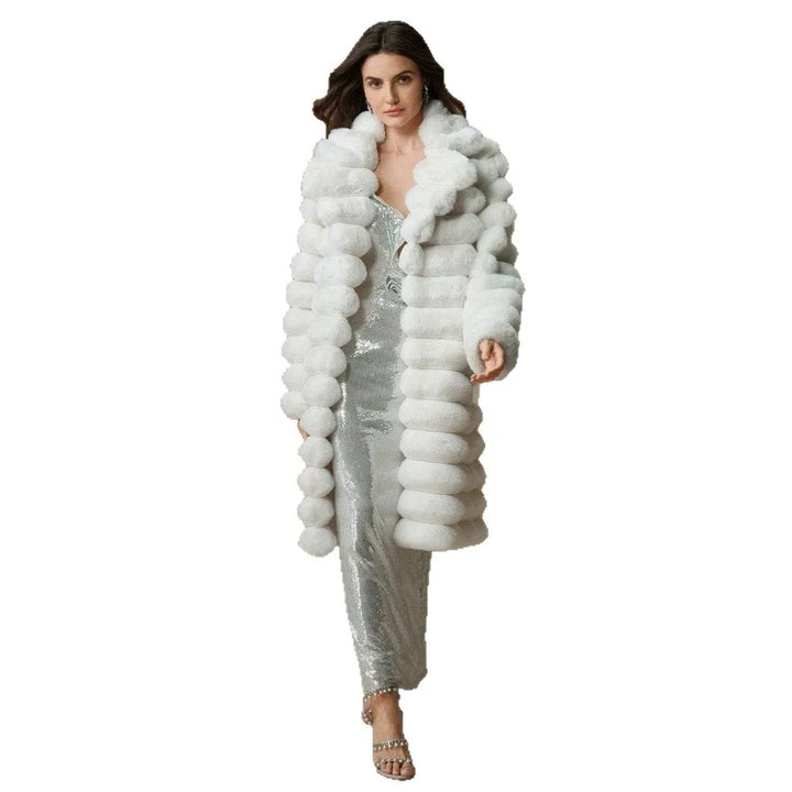 Model walking in white faux fur coat over sequin jumpsuit