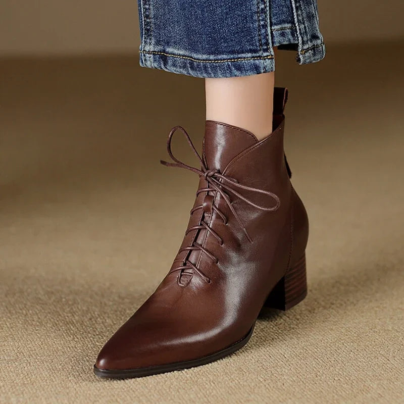 Brown leather lace-up ankle boot worn on model, front view