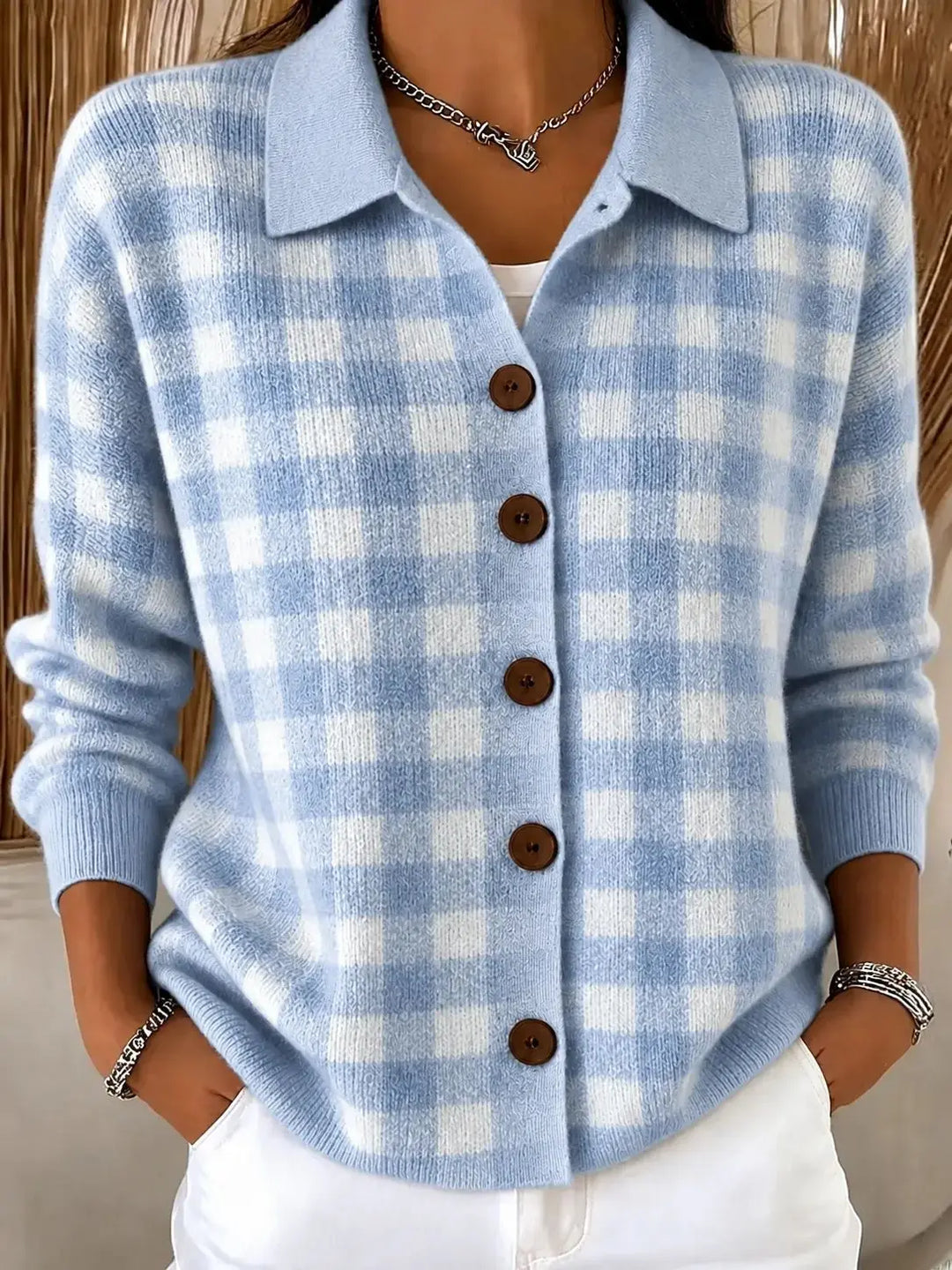 Woman wearing light blue gingham knit cardigan with collar and button front