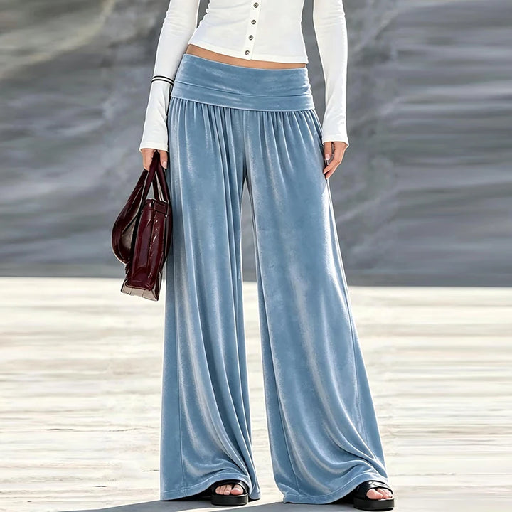 Woman wearing dusty blue velvet wide leg high waist pants, front view