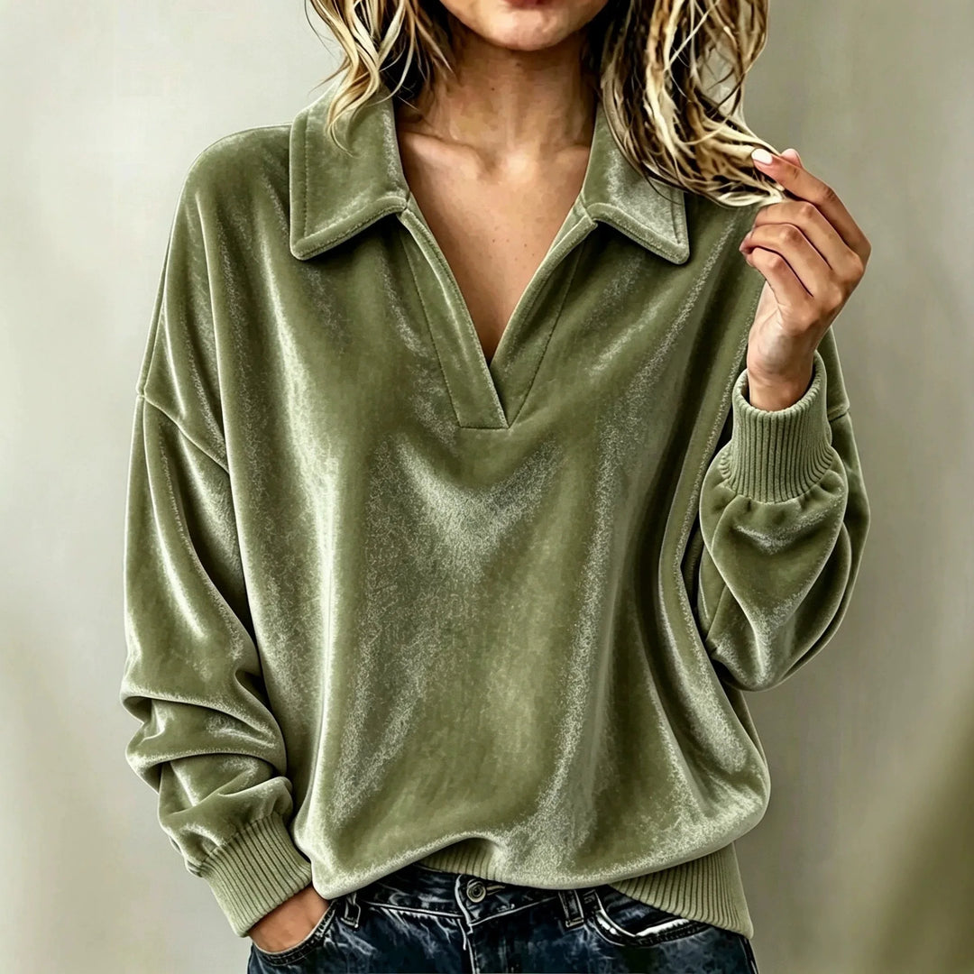 Woman wearing green velvet pullover top with johnny collar