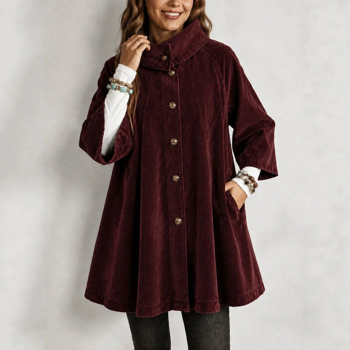 Woman wearing burgundy corduroy swing jacket buttoned up