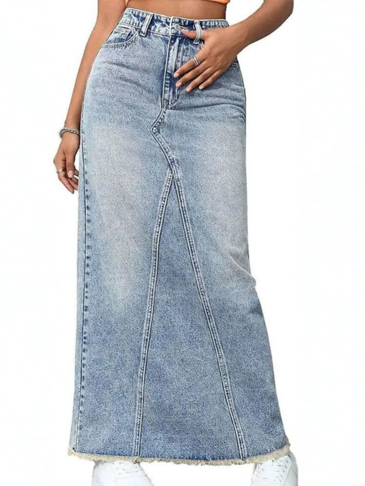 Front view of light blue high waist denim maxi skirt with curved seam detail